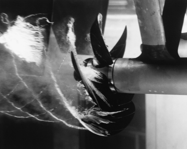Cavitation made visible on a ship's propeller. The same collapse, at scale, in the open.