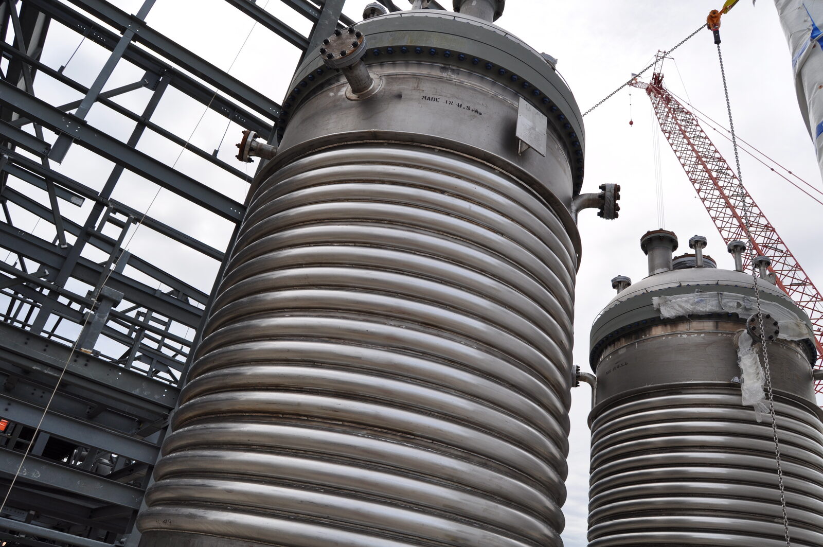 Jacketed reaction vessels. Depolymerisation is chemical-process engineering — heat, pressure, reagents, residence time, and the cost of all four.