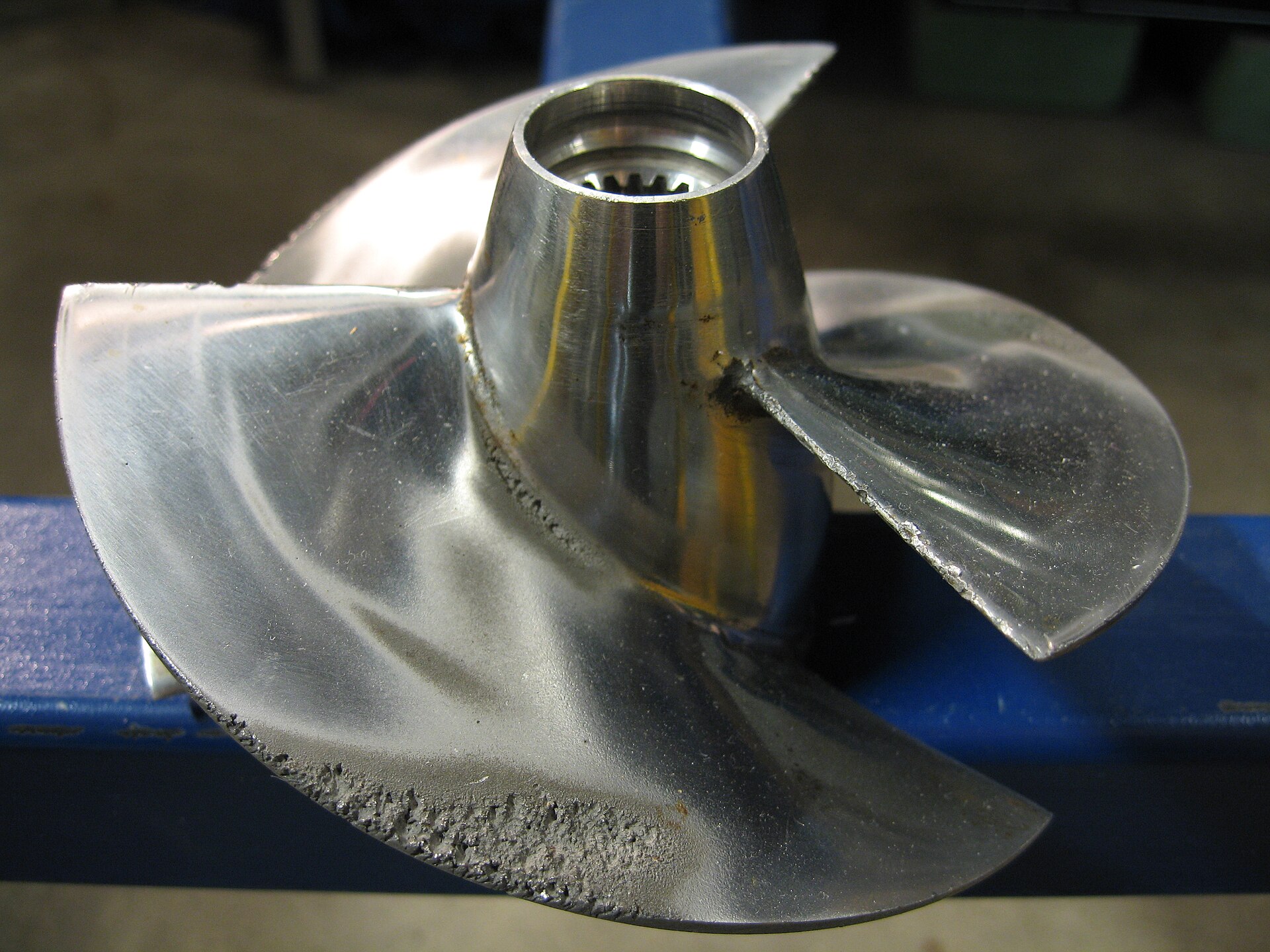 Cavitation erosion on a propeller blade. Bubble collapse pits solid bronze — which is a useful reminder of how much energy is in each implosion.