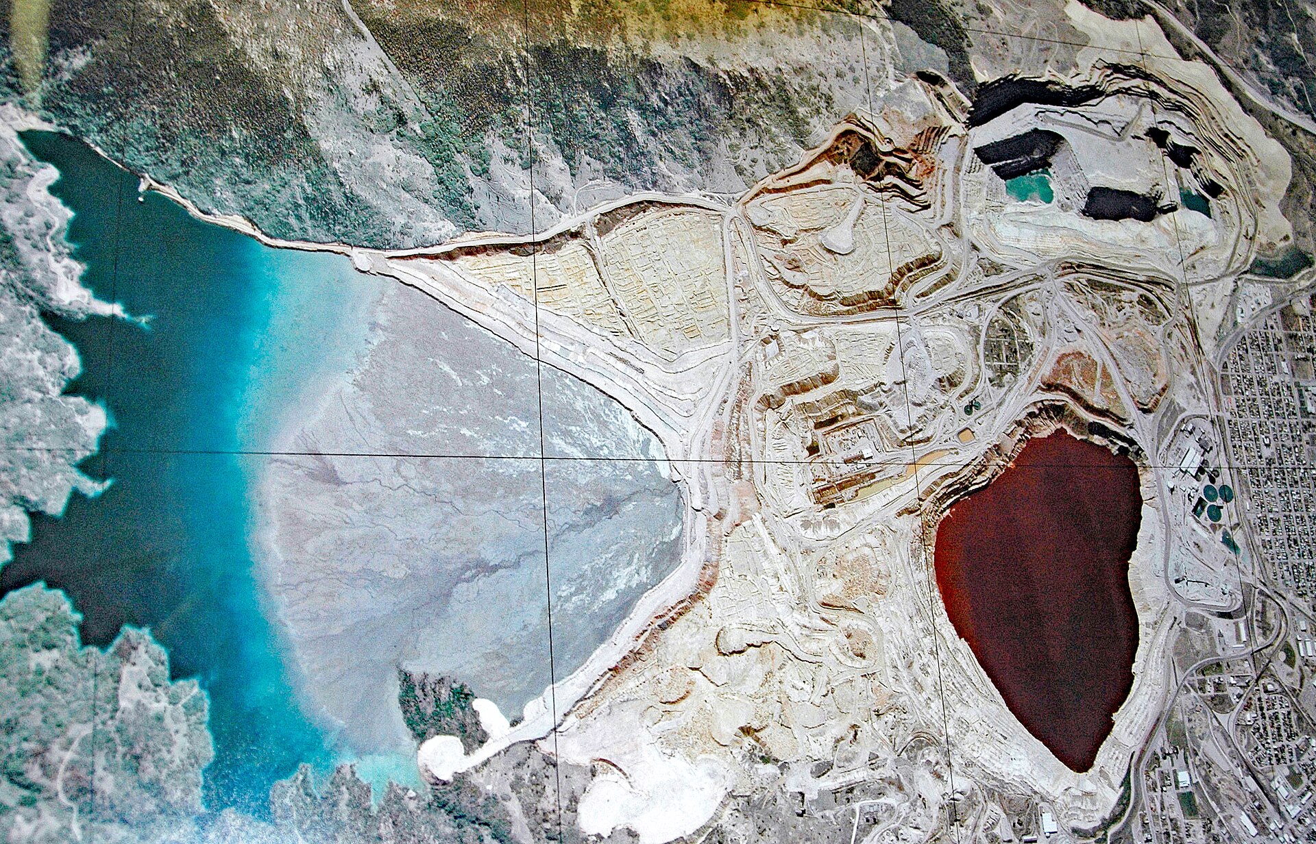 Stored tailings at scale. The resource argument is real — the recovery argument still has to be made.