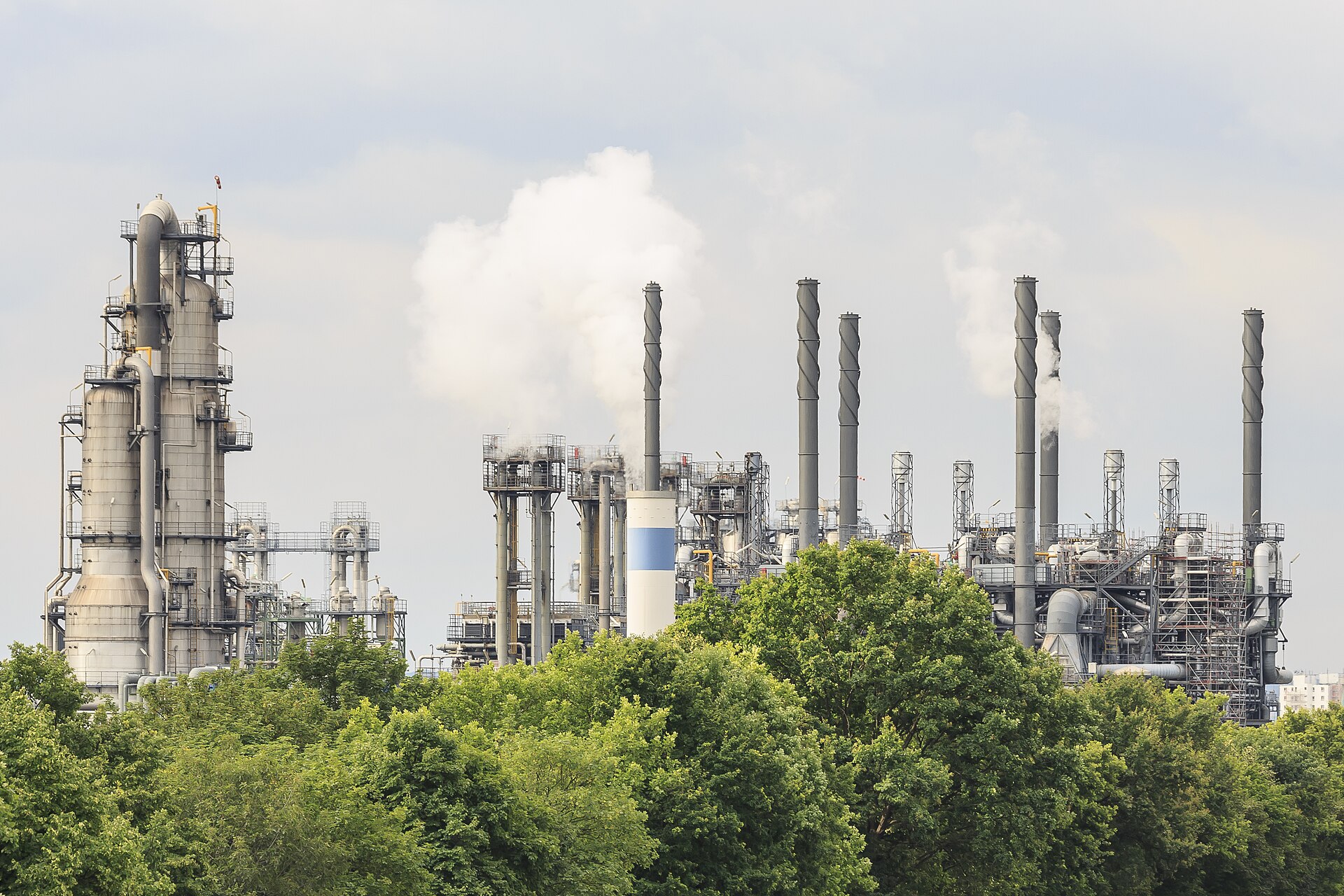 Off-site reclamation at chemical-plant scale. On-site systems trade this scale for shorter transport chains.