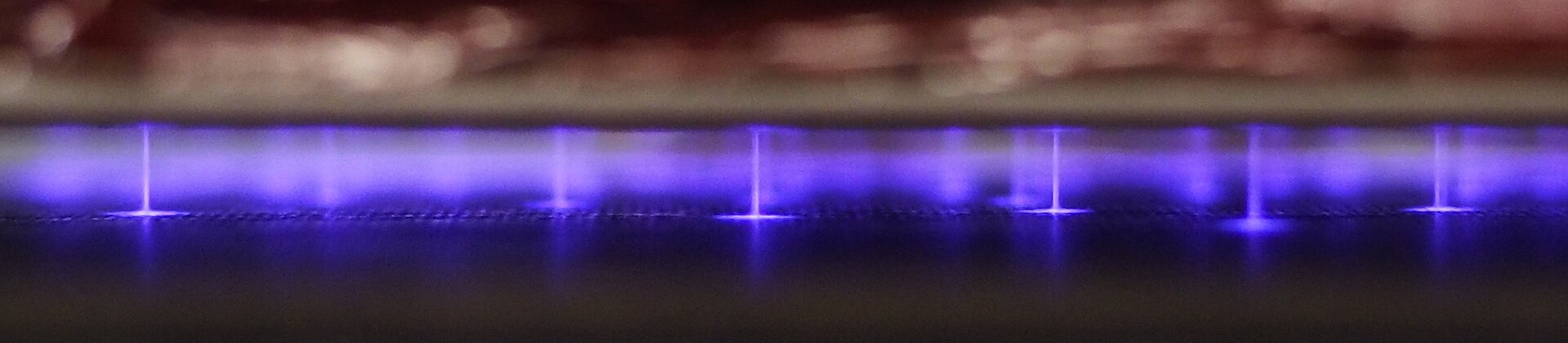 A filamentary dielectric barrier discharge. Each filament is a short-lived channel of energetic electrons; the gas around it stays cool enough to touch.