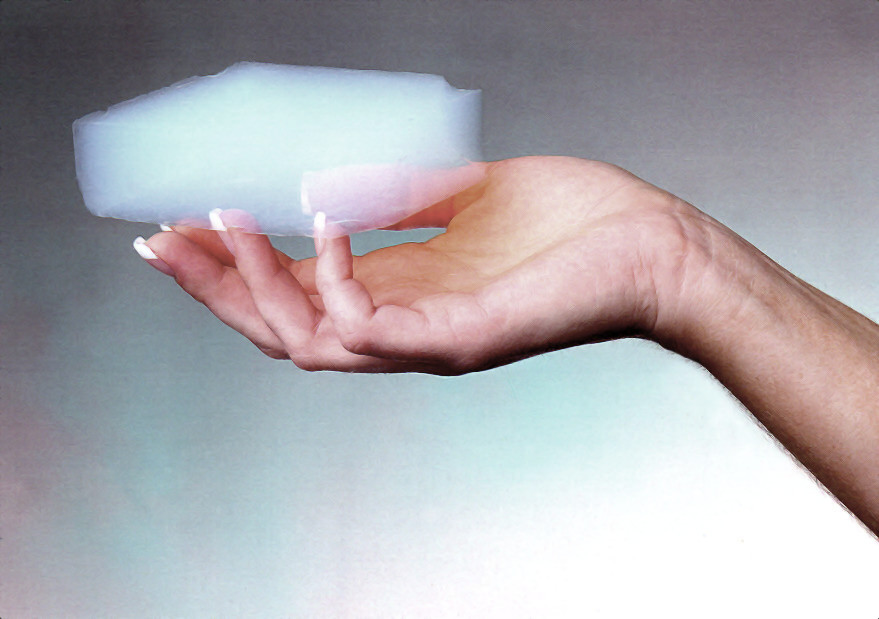 An aerogel block held in one hand. The material class is defined by its pore structure, not by any one chemistry.