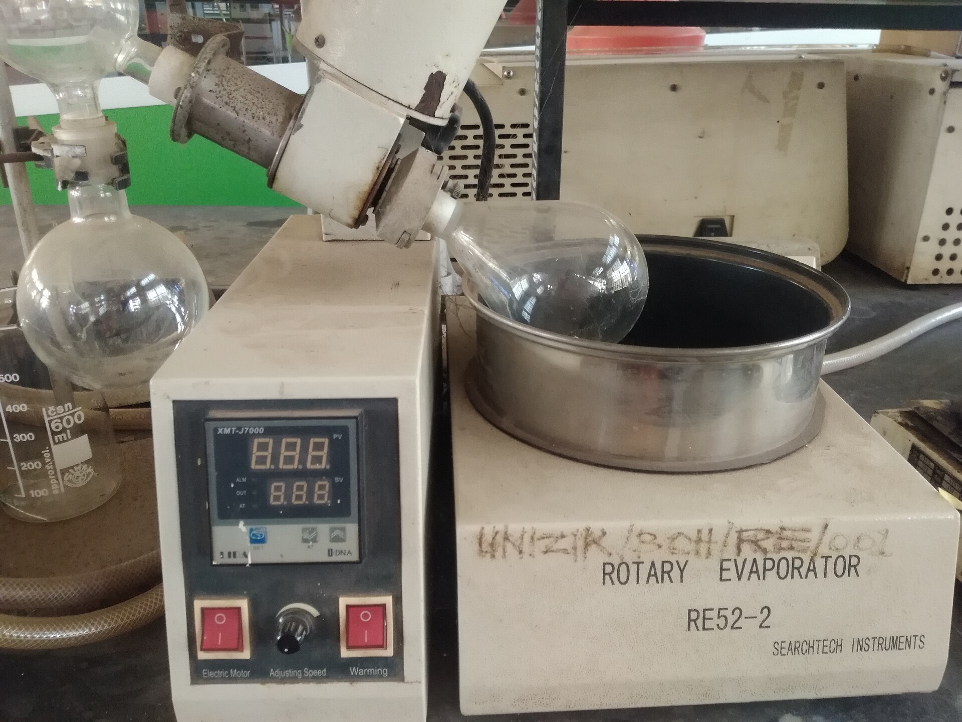 The lab-scale version of the same physics: heat, vapour, condenser, recovered liquid. Industrial units differ in scale and control, not in principle.